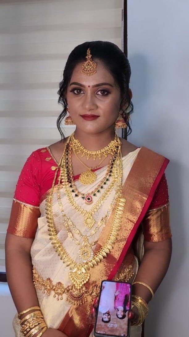 Bridal Innovation legacy portfolio look 3, showing Kerala bridal makeup, hair styling, saree, jewellery, or ceremony details.