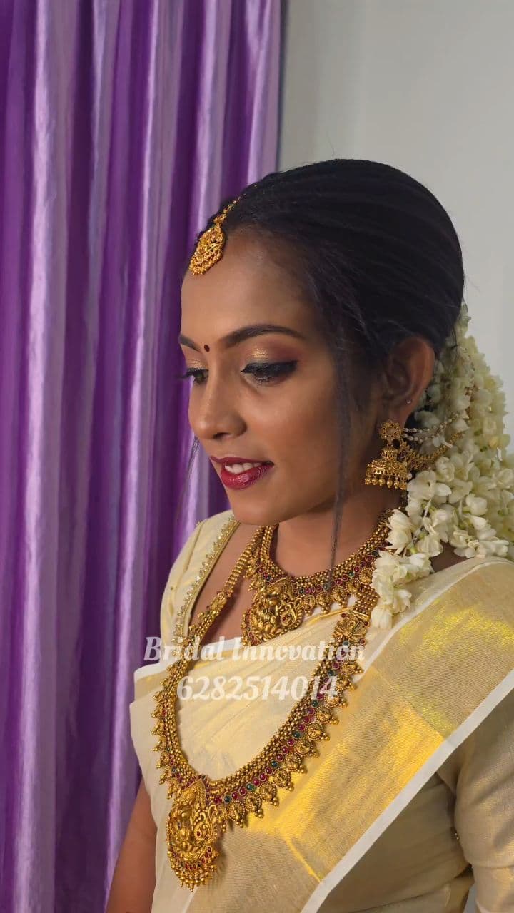 Bridal Innovation legacy portfolio look 13, showing Kerala bridal makeup, hair styling, saree, jewellery, or ceremony details.