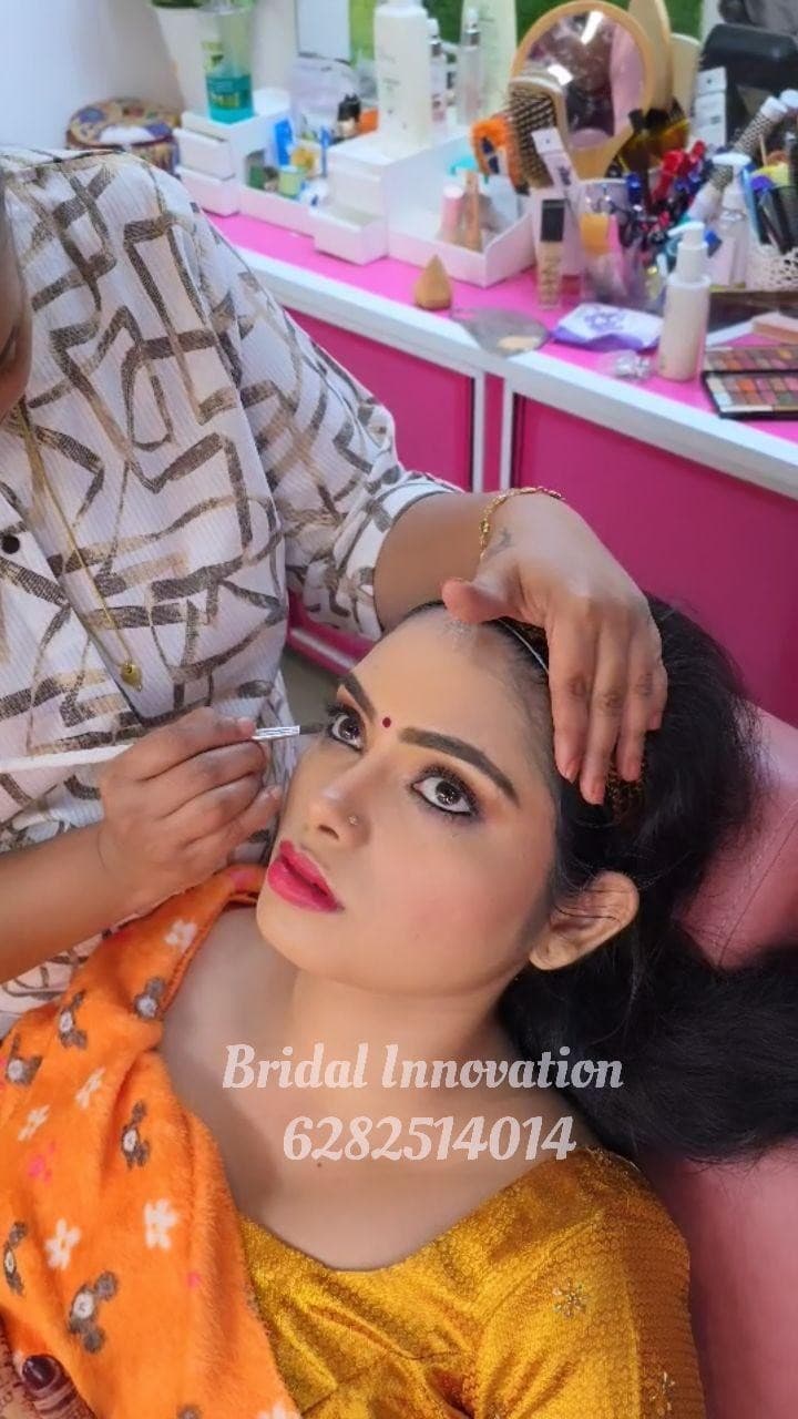 Bridal Innovation legacy portfolio look 14, showing Kerala bridal makeup, hair styling, saree, jewellery, or ceremony details.