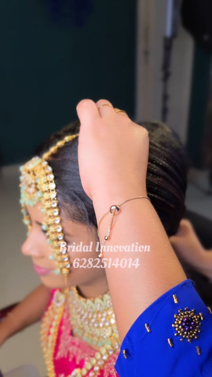 Bridal Innovation legacy portfolio look 18, showing Kerala bridal makeup, hair styling, saree, jewellery, or ceremony details.
