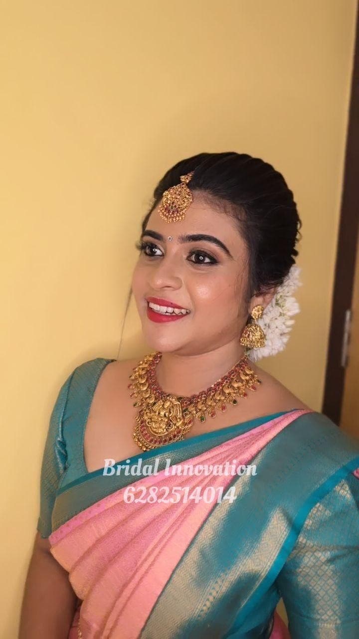 Bridal Innovation legacy portfolio look 30, showing Kerala bridal makeup, hair styling, saree, jewellery, or ceremony details.