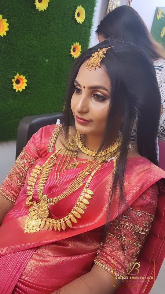Bridal Innovation legacy portfolio look 45, showing Kerala bridal makeup, hair styling, saree, jewellery, or ceremony details.