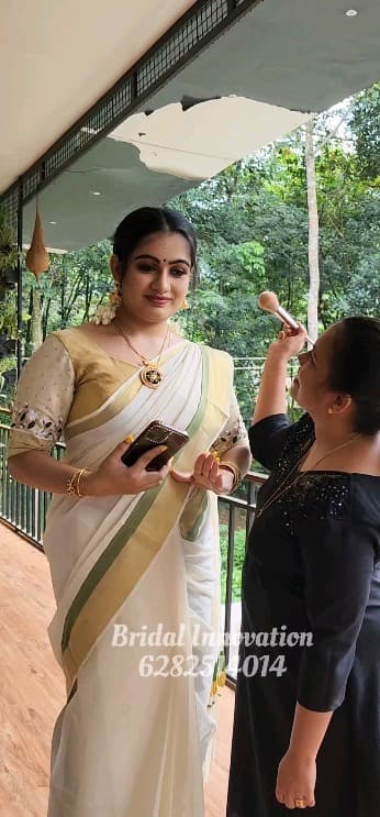Bridal Innovation legacy portfolio look 48, showing Kerala bridal makeup, hair styling, saree, jewellery, or ceremony details.