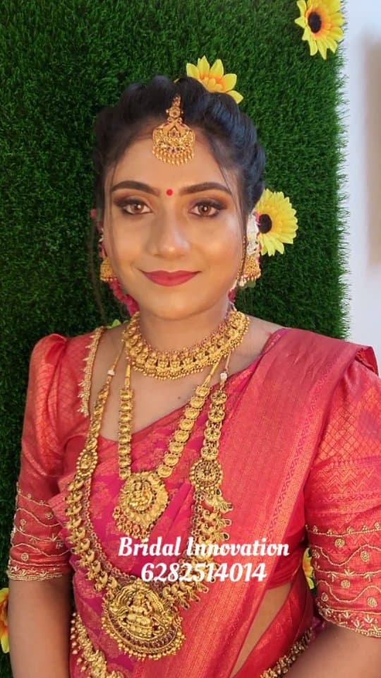 Bridal Innovation legacy portfolio look 64, showing Kerala bridal makeup, hair styling, saree, jewellery, or ceremony details.